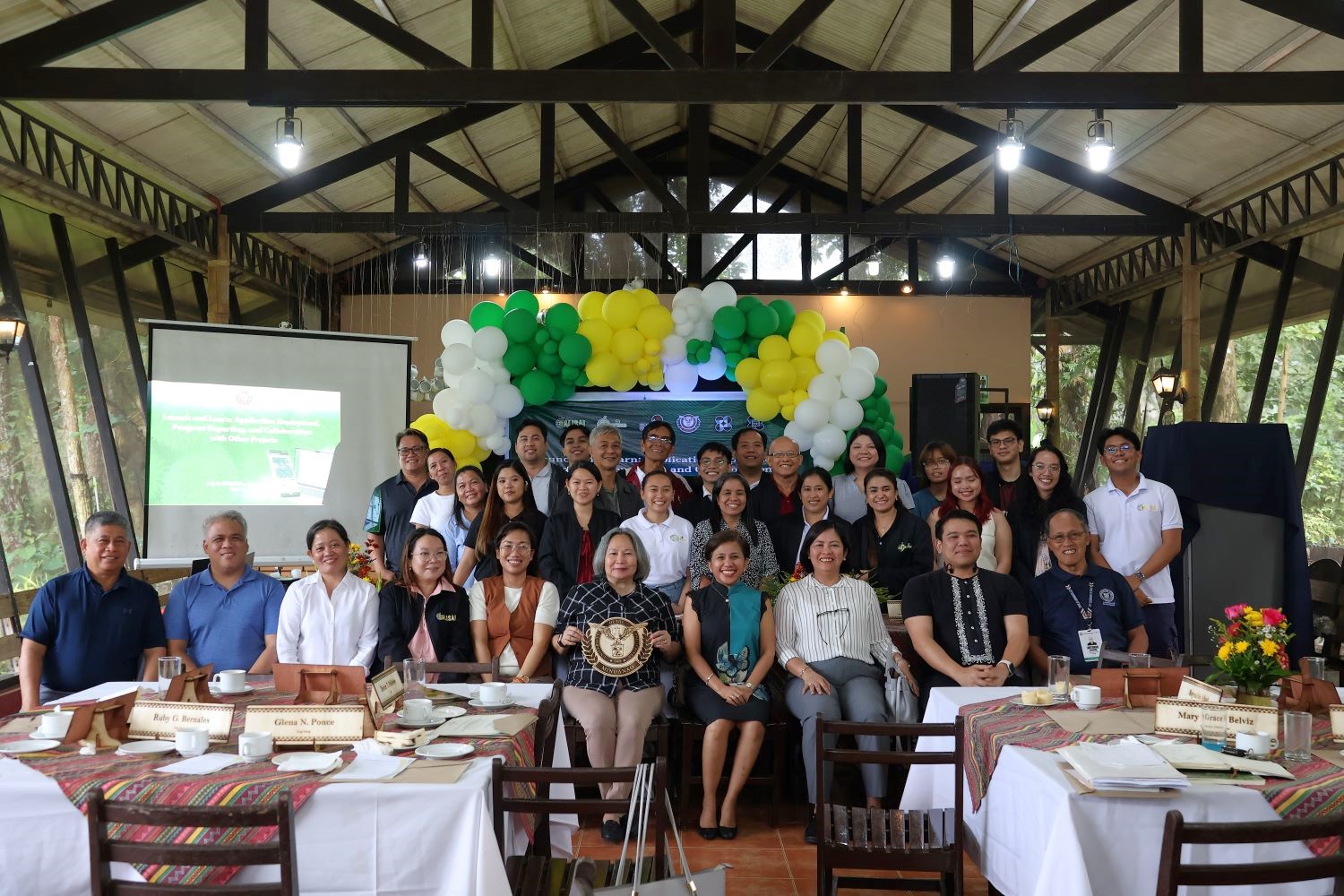 Farmers reviewing agricultural data on a tablet in an orchard